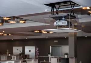 A projector lowered from a ceiling space with a projector lift